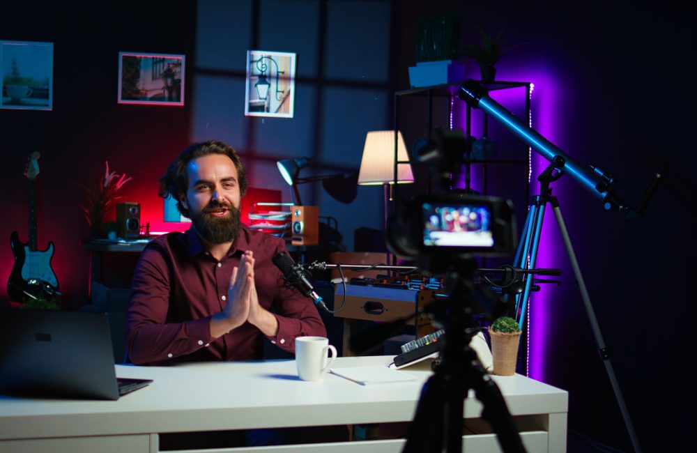 Content creator entering home studio, doing cool hand gesturing towards camera during live broadcast on online streaming platforms. Entertainer pointing fingers, captivating audience, camera B
